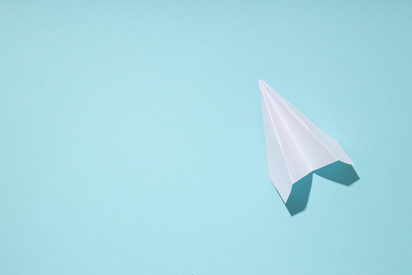 Business, startup and sponsorship concept with paper plane on bl